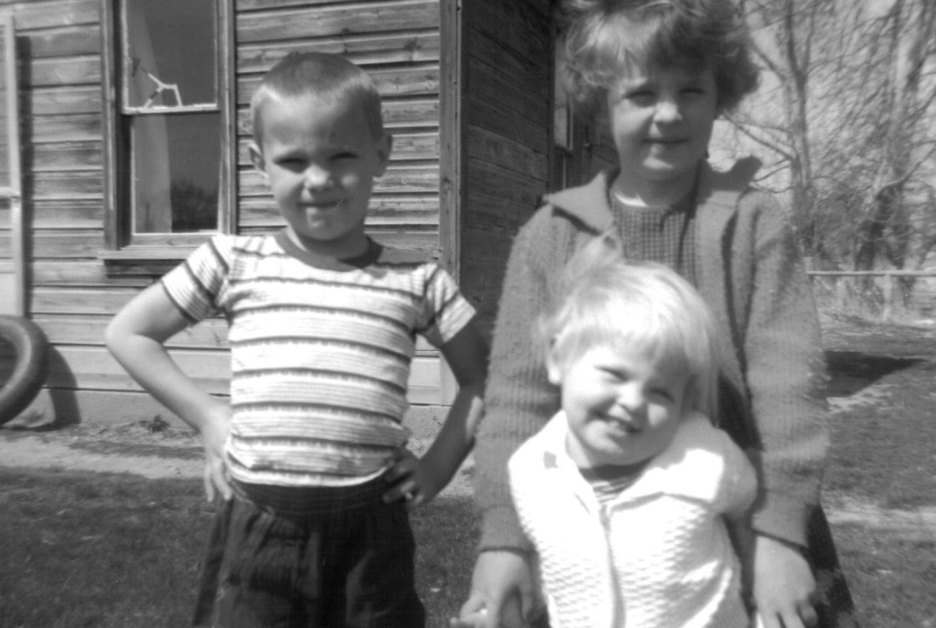 Peter, Debbie, and Kathy standing outside their home